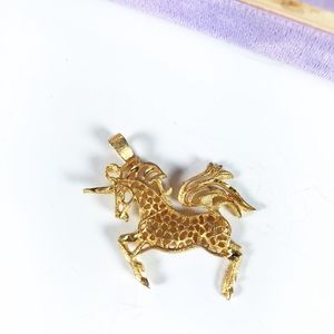Goldtone filigree opencut unicorn pendant,